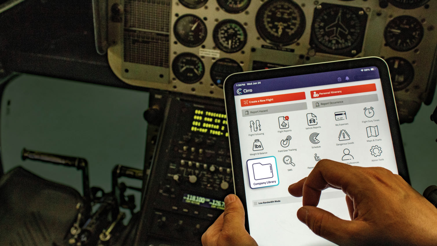 A helicopter pilot's POV of looking at a tablet with the Cirro dashboard on it in a cockpit. The "Company Libary" module is popping off the screen.