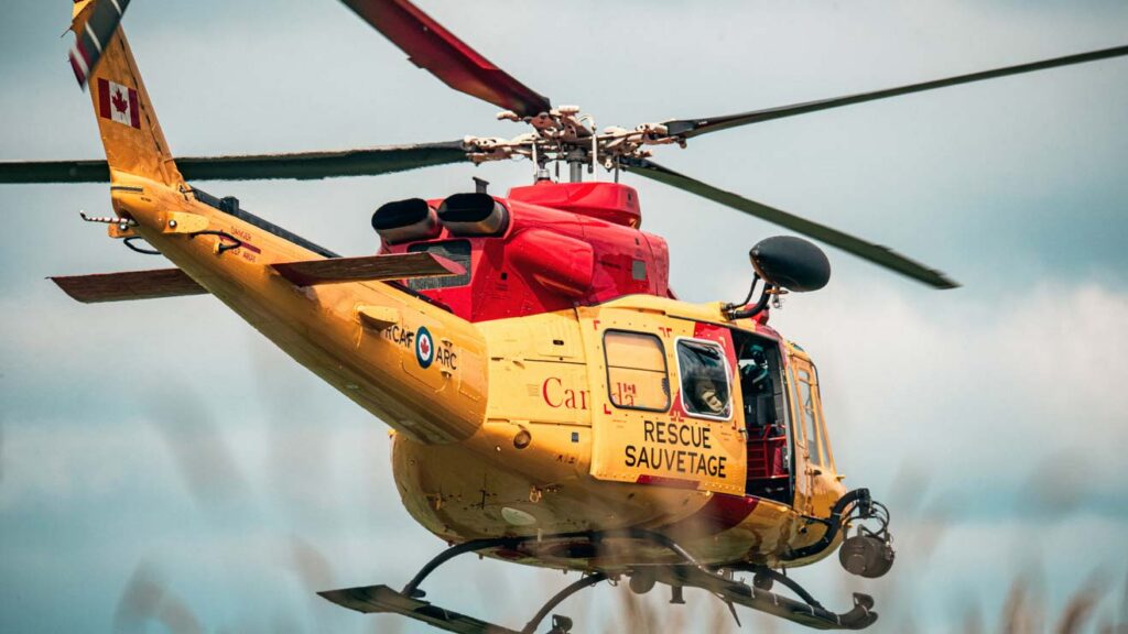 A yellow and red Canadian rescue helicopter.